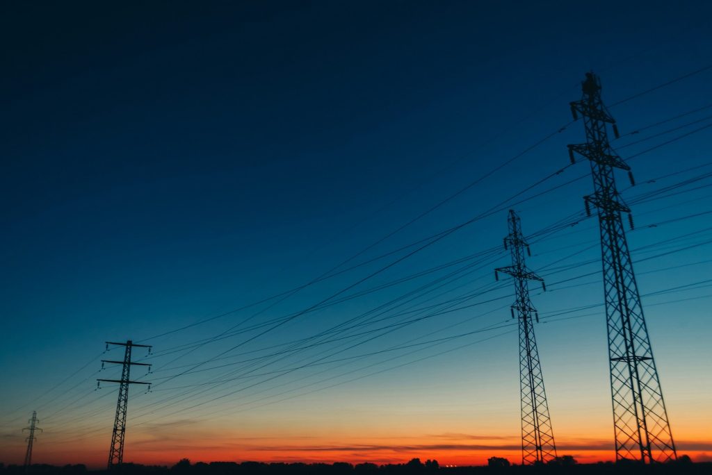 Electricity pylons against a dusk sky